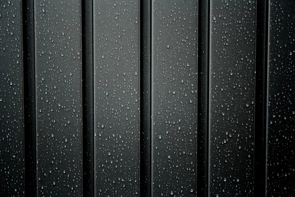 Черный металлический профиль с капли дождя — стоковое фото